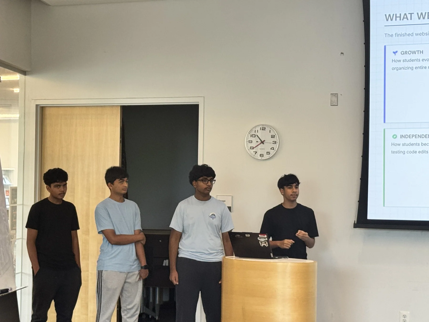 OpenByte team members and volunteers presenting together at a coding Demo Day